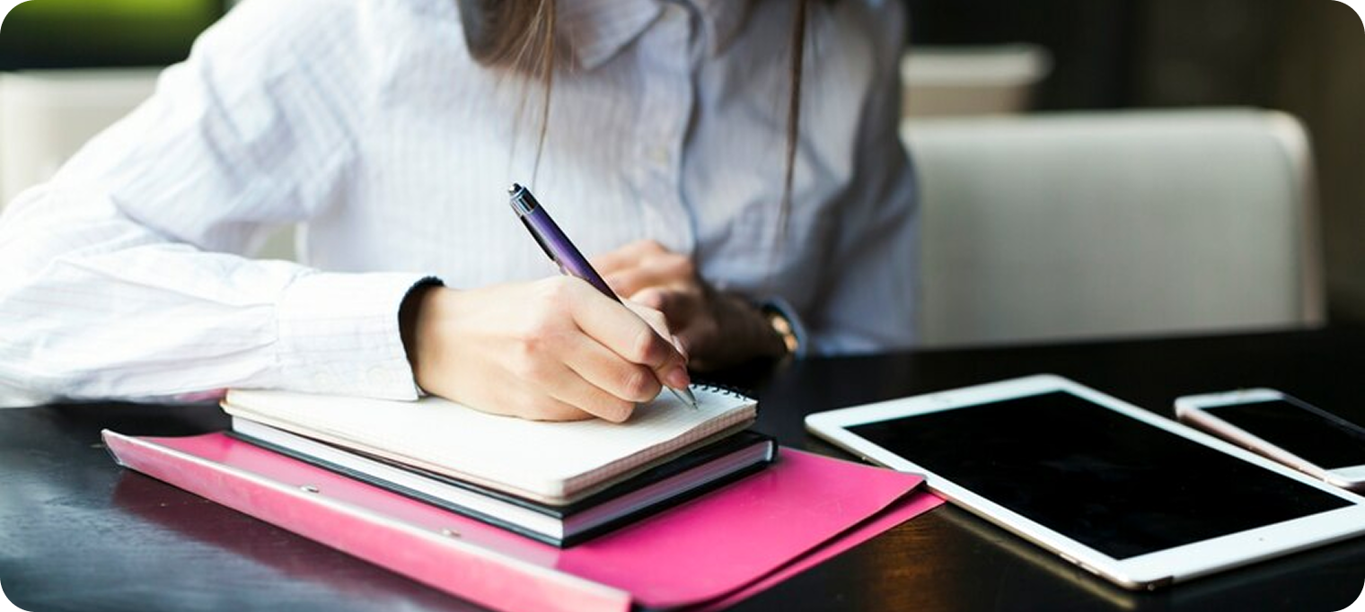 Person writing in notebook
